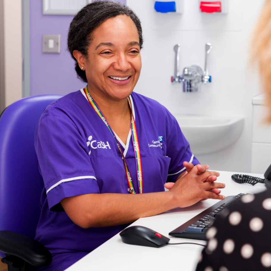 Smiling Icash Nurse Speaking To A Service User At A Desk (Smaller)