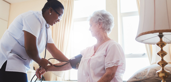 Nurse measuring the blood pressure of a patient.