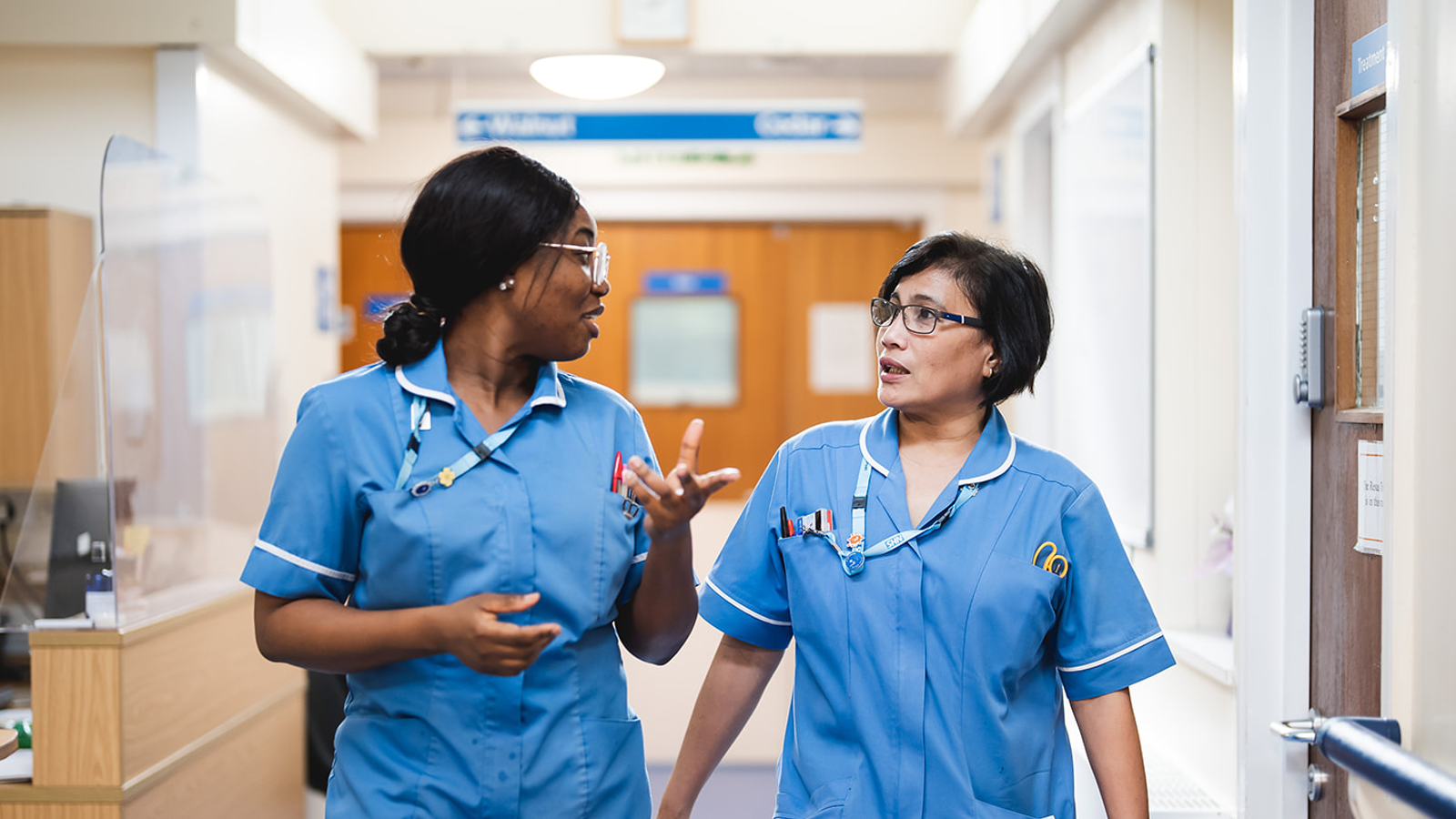 2 Nurses Talking In Norwich Hospital Corridor