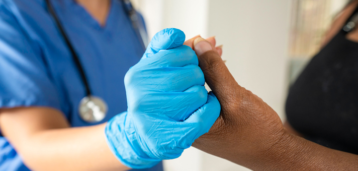 Nurse And Patient Holding Hands