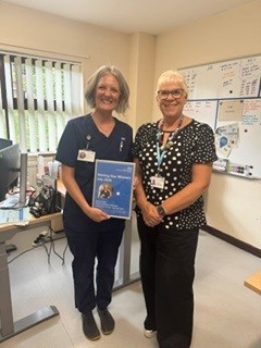 Jo Taylor holding Shining Star award