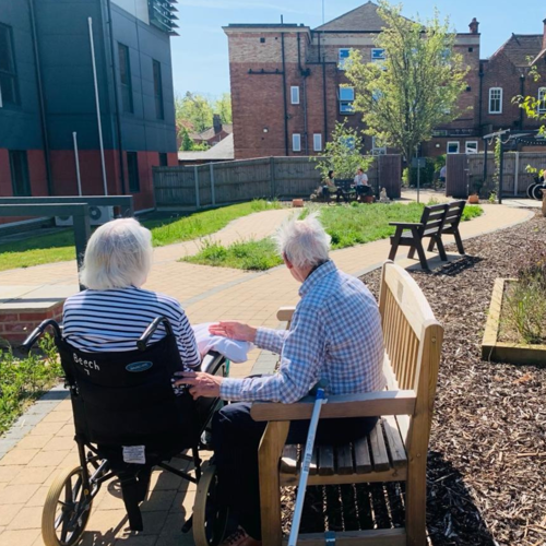 Elderly couple sitting in Mulbury Gardens