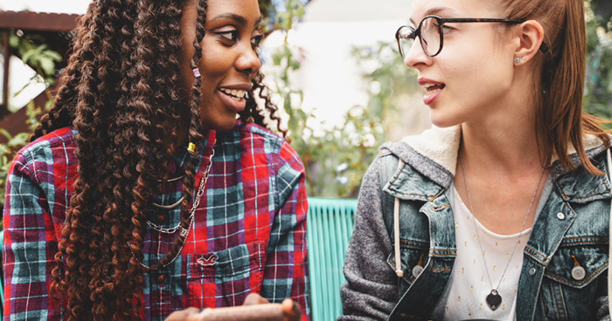 Two teenage girls sat outside talking
