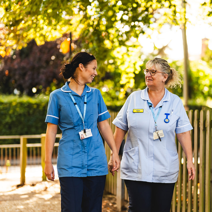 2 Nurses walking and laughing outside