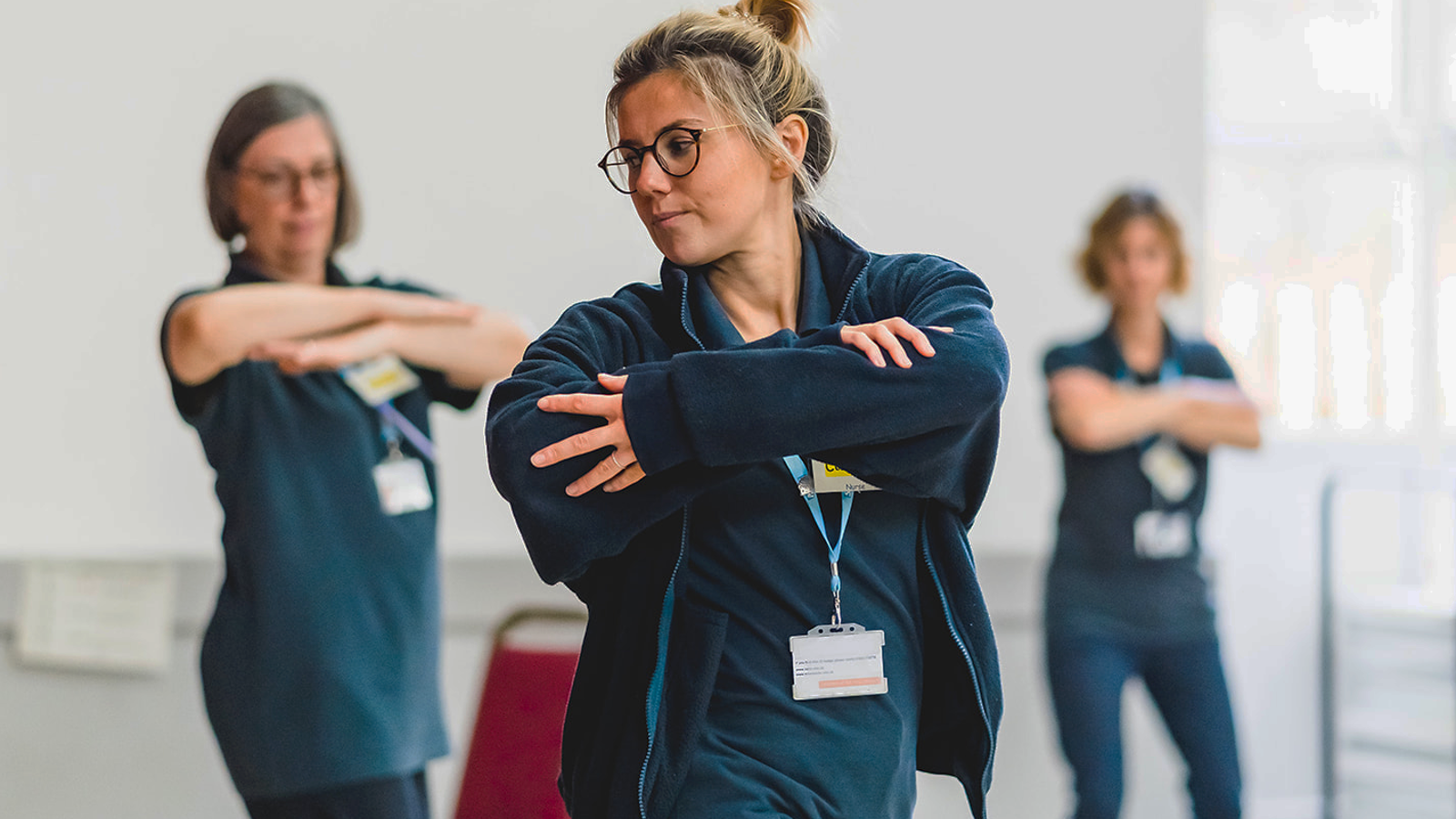 3 Clinicans Demonstrating A Stretch