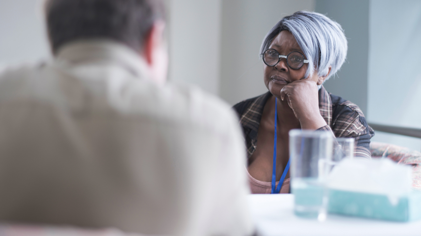 NHS Worker talking to adult man