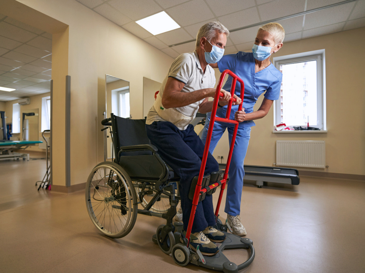 Physical Therapist Helping Stroke Patient In Rehab Center