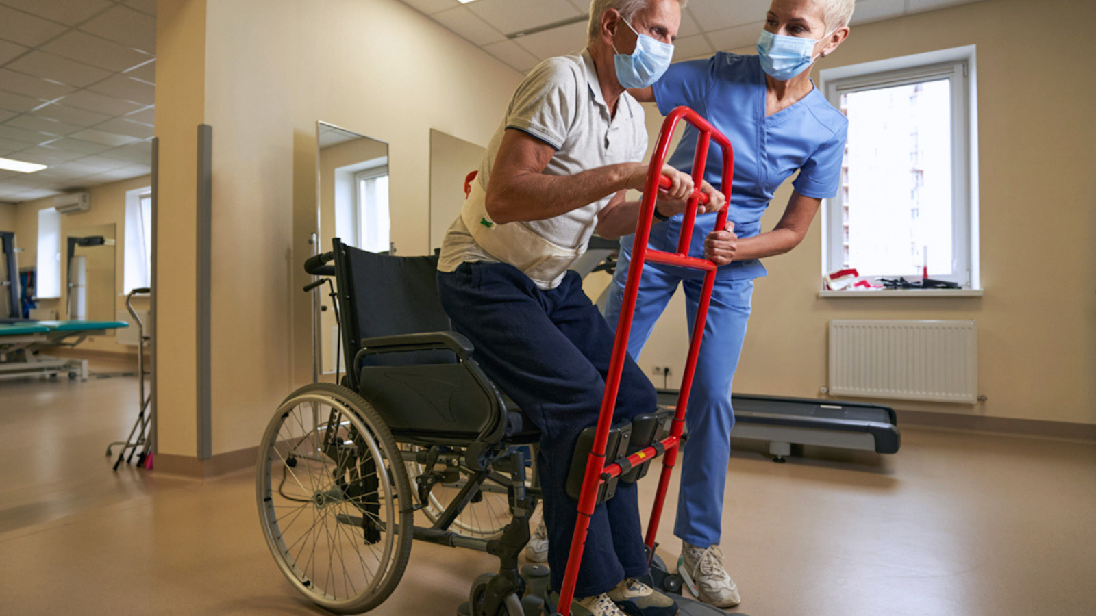 Physical Therapist Helping Stroke Patient In Rehab Center