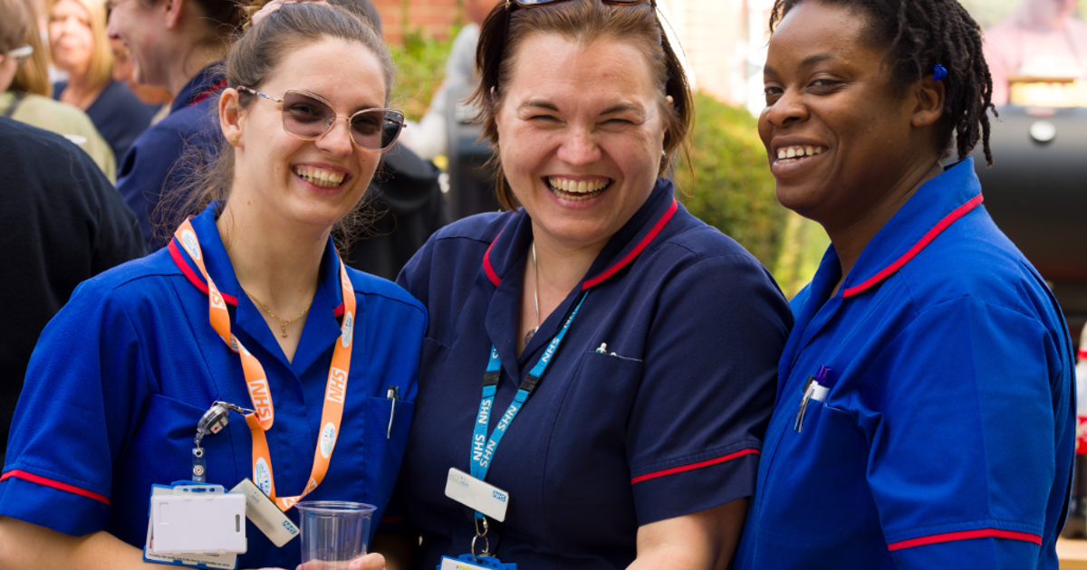3 NHS nurses smiling and laughing