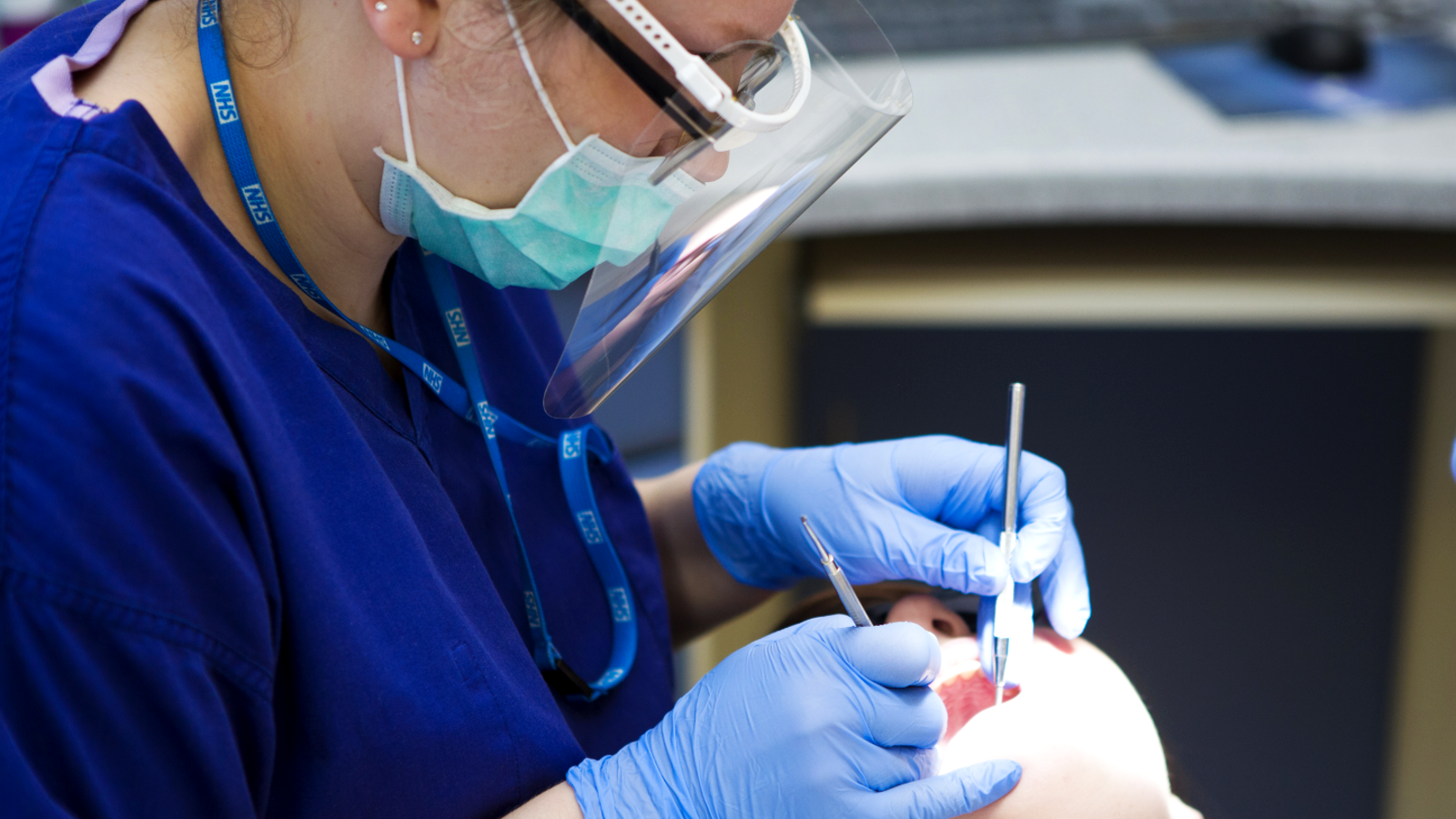 Dental Clinican Looking In The Mouth Of A Person 4X3