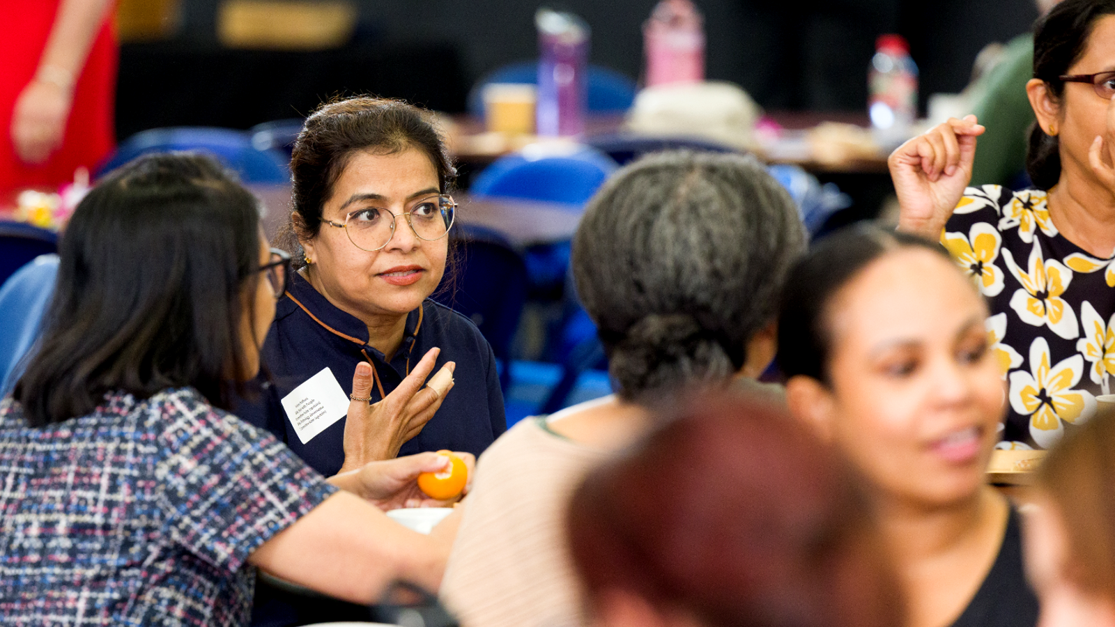Staff talking amongst themselves at a conference.