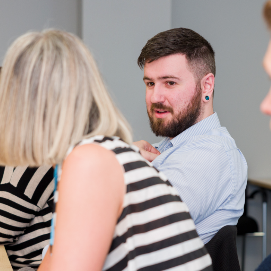 Man in meeting listening to conversation
