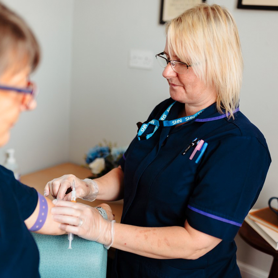 Nurse Taking Blood From Patient In Their Home In Virtual Ward